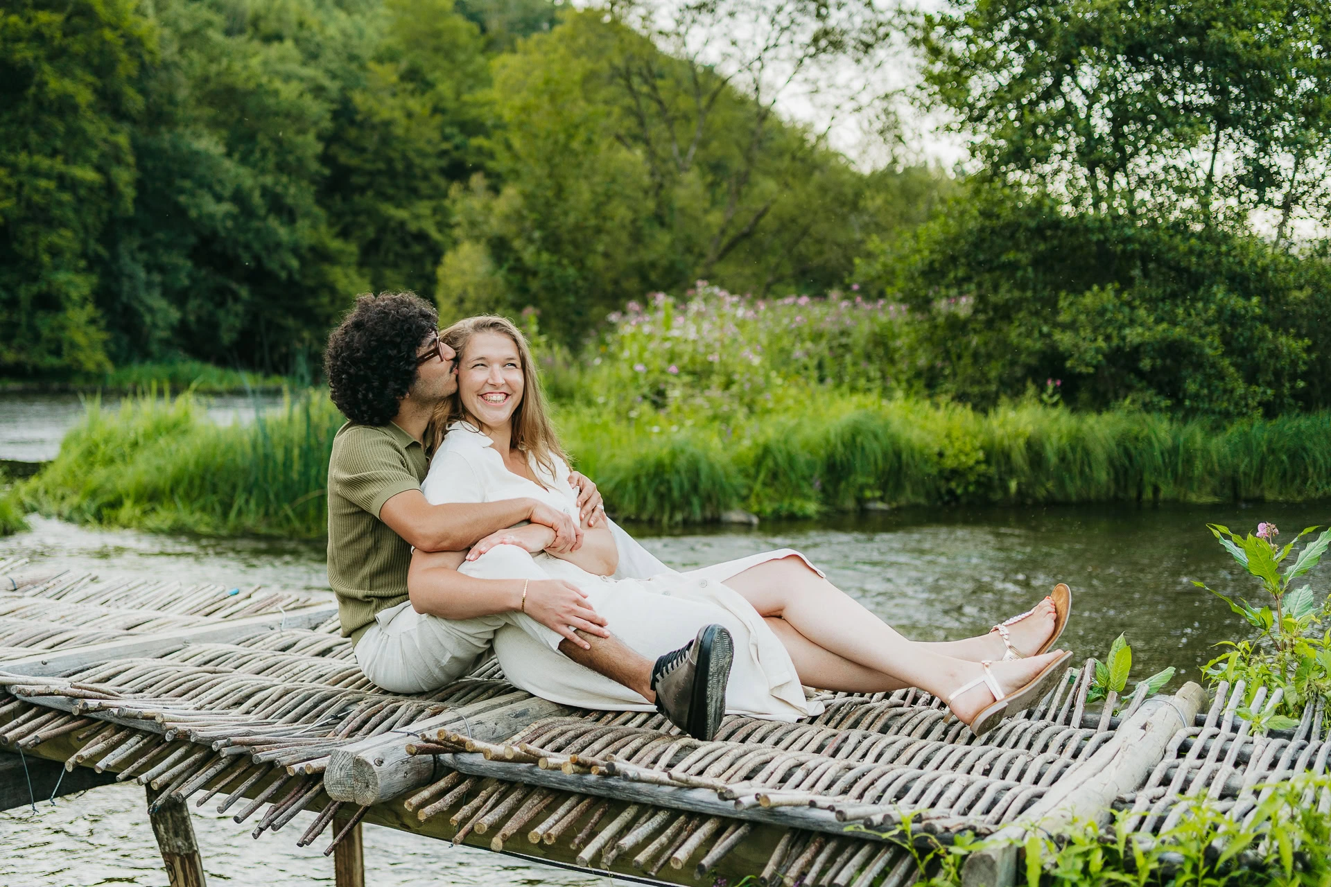 Couple assis dans l'herbe lors d'une séance en extérieur
